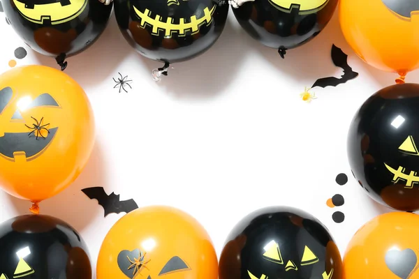 Frame made of Halloween balloons on white background, closeup