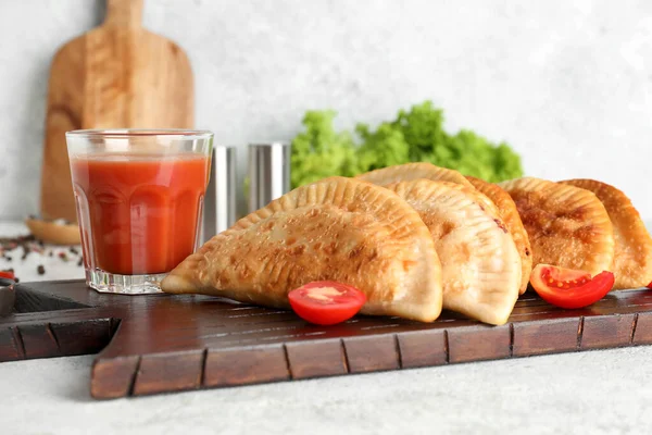 Wooden Board Tasty Chebureks Glass Tomato Juice Light Table Closeup — Stock Photo, Image