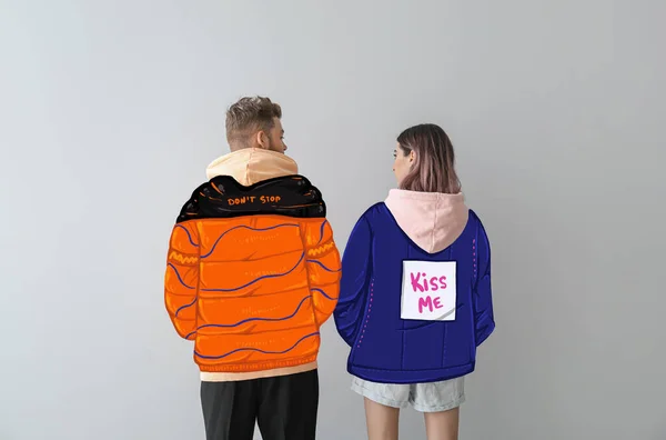 Young Couple Stylish Drawn Coats Light Background Back View — Stock Photo, Image