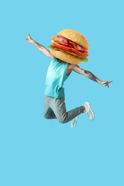 Jumping Tattooed Man Tasty Burger Instead His Head Light Blue — Stock Photo, Image