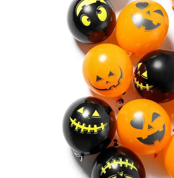 Different Halloween balloons on white background