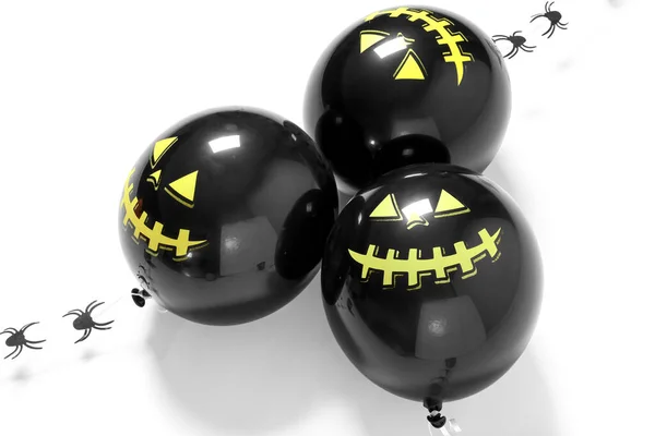 Black Halloween balloons on white background