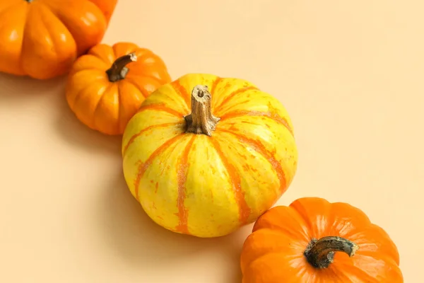 Ripe pumpkins for Halloween party on color background, closeup
