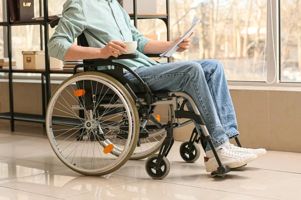 Young man with physical disability working in office