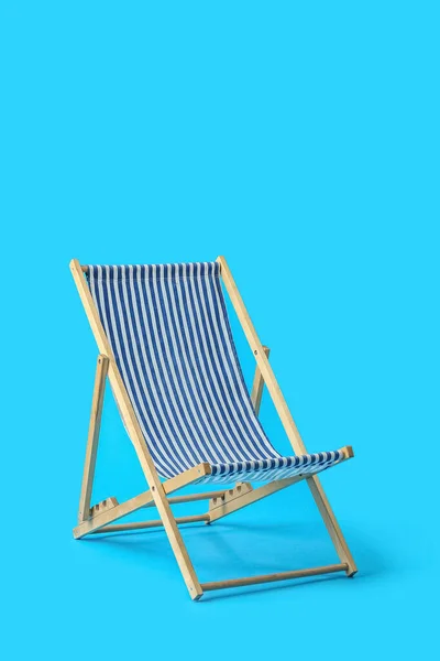 Beach deck chair on light blue background