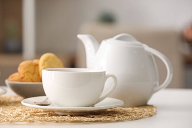 Kafedeki masada bir fincan sıcak çay ve demlik