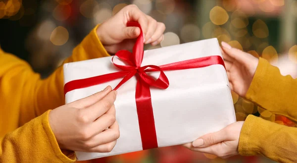 Woman Giving Present Her Friend Christmas Eve Closeup — Stock Photo, Image