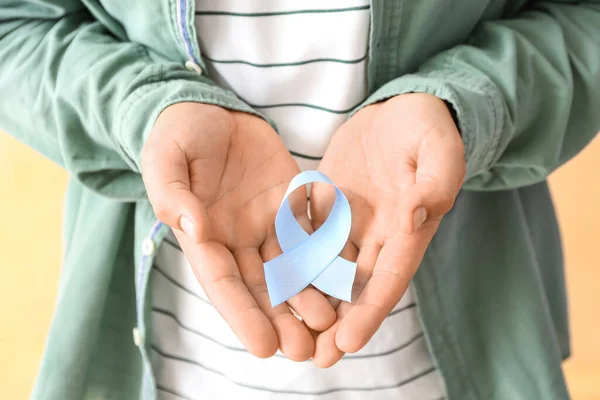 Man Blue Awareness Ribbon Beige Background Closeup Prostate Cancer Concept — Stock Photo, Image