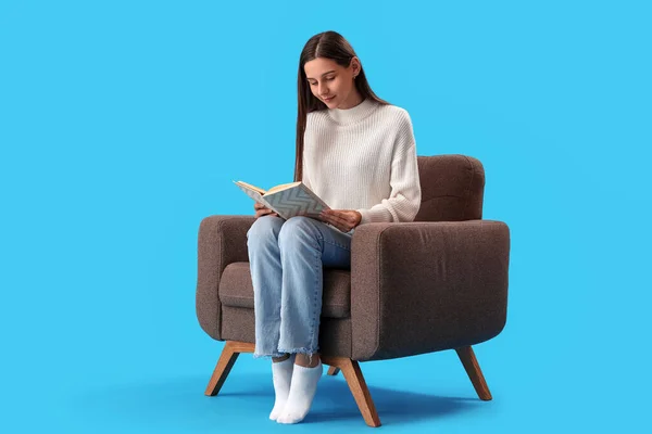 Beautiful Woman Reading Book Armchair Blue Background — Stock Photo, Image