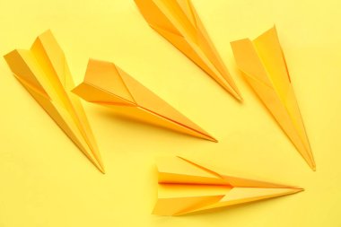 Paper planes on yellow background