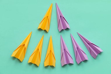 Colorful paper planes on blue background