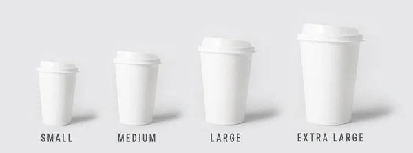 Different sized takeaway coffee cups on light background