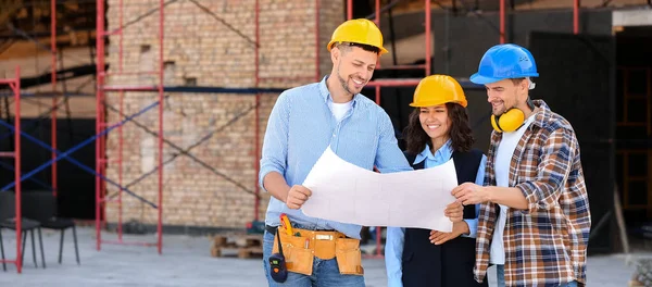 Architects discussing project of building at construction site