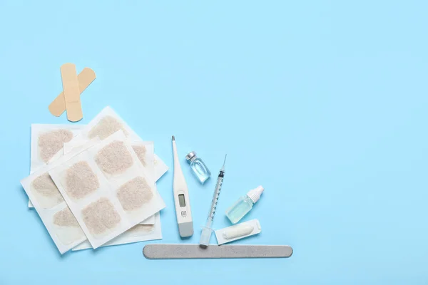 Mustard plasters and medicines on blue background