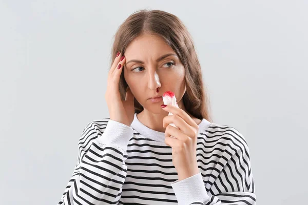 Mujer Joven Con Hemorragia Nasal Tejido Sobre Fondo Claro Primer — Foto de Stock