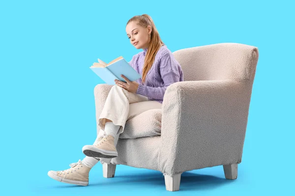 Young Woman Reading Book Armchair Blue Background — Stock Photo, Image