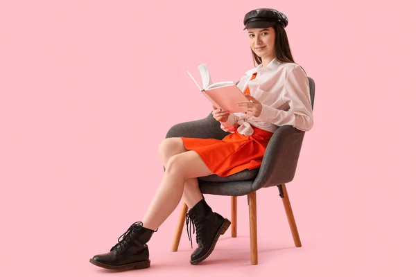 Stylish Young Woman Reading Book Armchair Pink Background — Stock Photo, Image