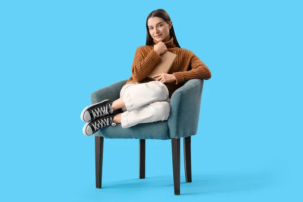Young Woman Book Sitting Armchair Blue Background — Stock Photo, Image