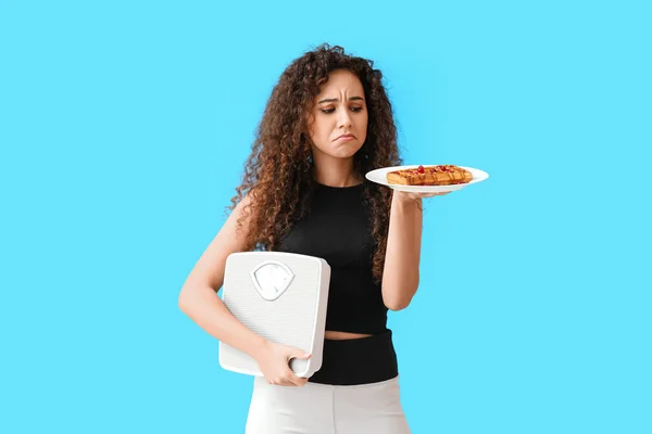 Young African American Woman Weight Scales Pastry Blue Background Diet — Stock Photo, Image