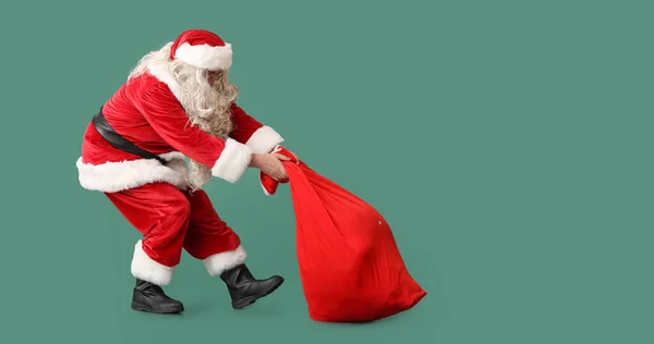 Santa Claus Heavy Bag Green Background Space Text — Stock Photo, Image