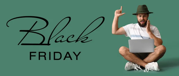 Surprised Young Man Laptop Pointing Something Green Background Black Friday — Stock Photo, Image