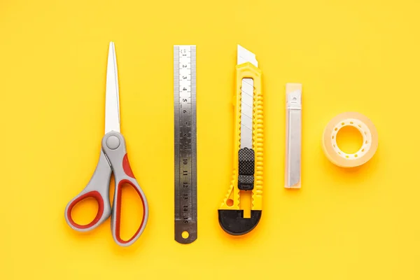 Utility Knife Scissors Ruler Blades Adhesive Tape Yellow Background — Stock Photo, Image