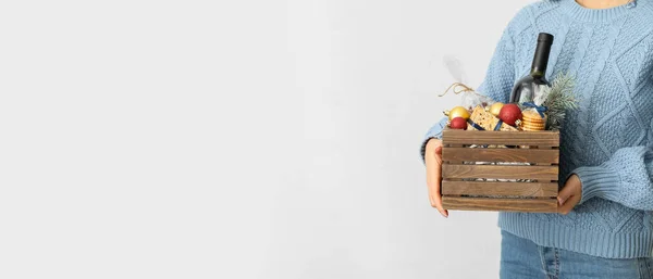 Woman Holding Gift Basket Products Wine Christmas Decor Light Background — Stock Photo, Image