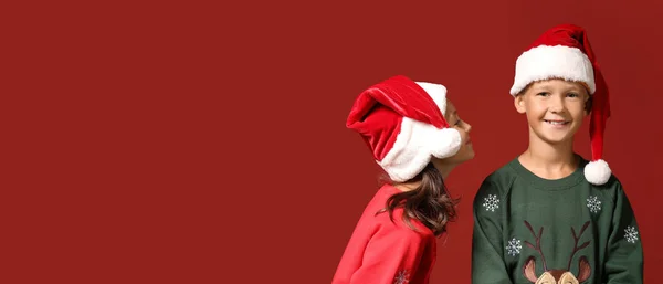 Niños Felices Suéteres Navidad Sombreros Santa Sobre Fondo Rojo Con —  Fotos de Stock