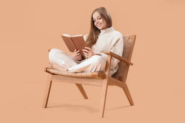 Young Woman Reading Book Armchair Beige Background — Stock Photo, Image