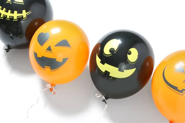Funny Halloween balloons on white background, closeup
