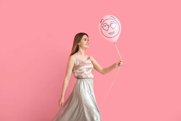 Beautiful Young Woman Holding Balloon Drawn Emoticon Pink Background — Stock Photo, Image