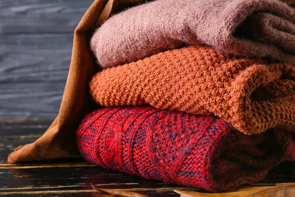 Stack Children Sweaters Dark Wooden Table Closeup — Stock Photo, Image