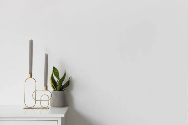 Stylish Holder Candles Houseplant Chest Drawers White Wall — Stock Photo, Image