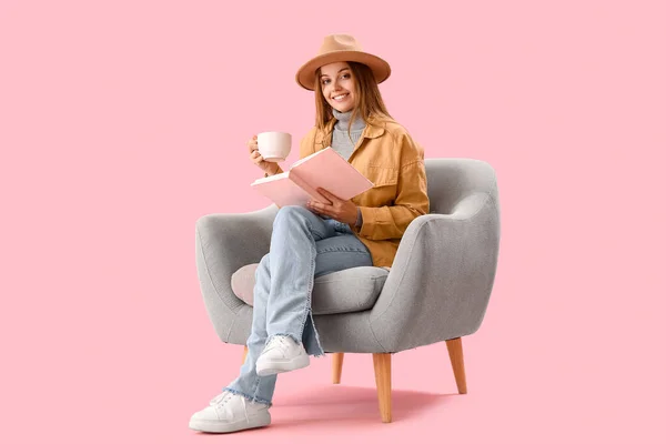 Young Woman Cup Hot Cocoa Reading Book Armchair Pink Background — Stock Photo, Image