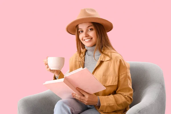 Young Woman Cup Hot Cocoa Reading Book Armchair Pink Background — Stock Photo, Image