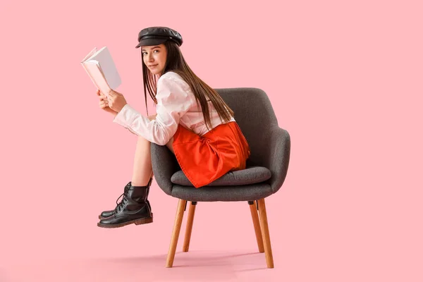 Stylish Young Woman Reading Book Armchair Pink Background — Stock Photo, Image