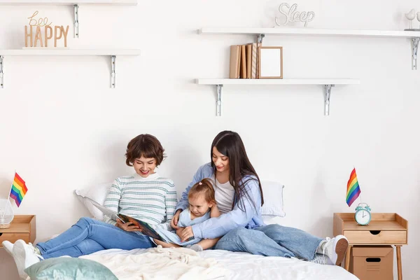 Lesbian Couple Reading Story Little Daughter Bedroom — Stock Photo, Image