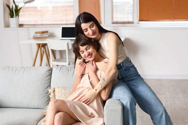 Mujer Embarazada Joven Con Esposa Abrazándose Sofá Casa — Foto de Stock