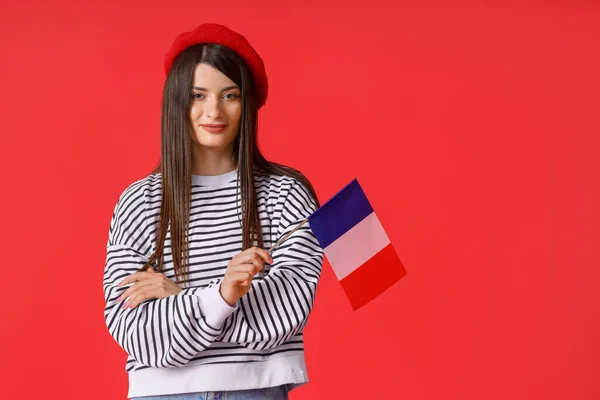 Hermosa Joven Con Bandera Francia Sobre Fondo Rojo —  Fotos de Stock