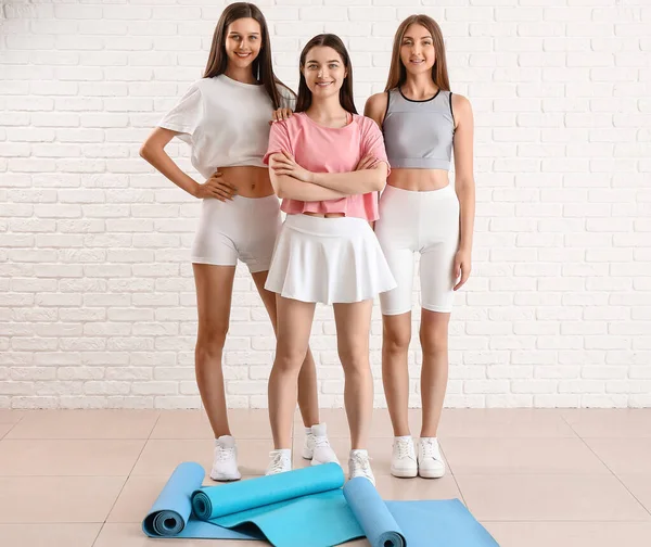 Mujeres Jóvenes Deportivas Con Colchonetas Yoga Cerca Pared Ladrillo Blanco — Foto de Stock