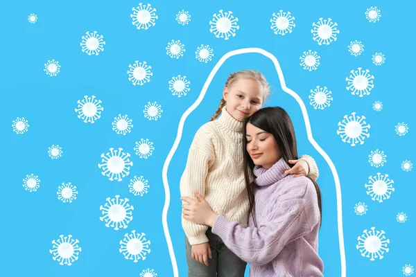 Happy woman with her little daughter and drawn virus on blue background. Concept of strong immunity