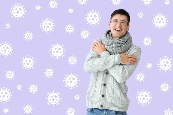 Happy young man and drawn virus on lilac background. Concept of strong immunity