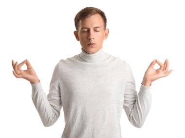 Genç adam beyaz arka plan üzerinde meditasyon yapıyor.