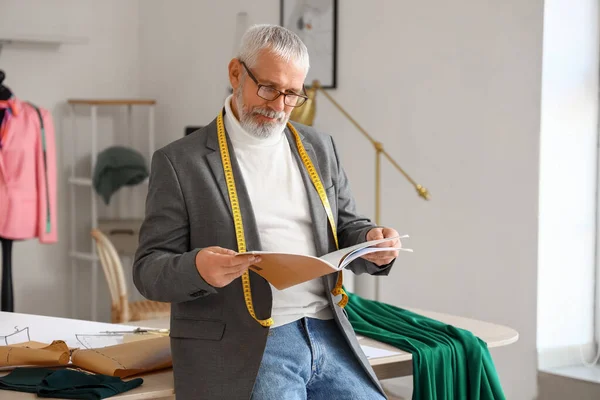 Mature Fashion Designer Reading Magazine Studio — Stock Photo, Image