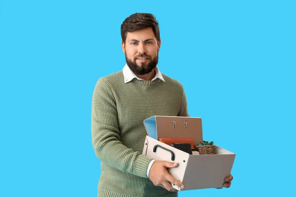 Smiling Fired Young Man Holding Box Personal Stuff Blue Background — Stok Foto
