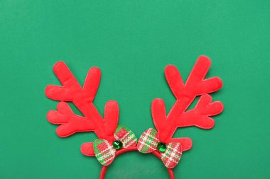 Yeşil arka planda Noel geyiği boynuzları