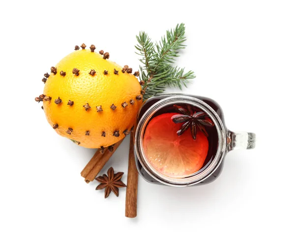 Mason jar of aromatic mulled wine and orange on white background