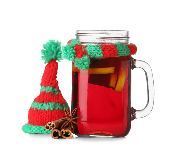 Mason jar of tasty mulled wine with knitted hat and scarf isolated on white background