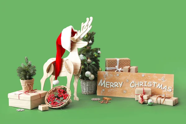 Board Text Merry Christmas Wooden Reindeer Fir Tree Presents Green — Stock Photo, Image