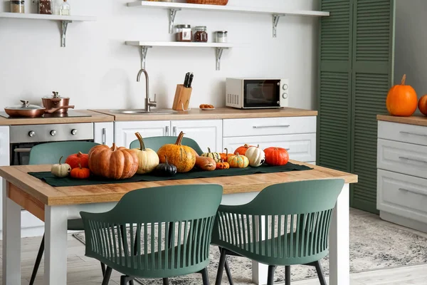 Halloween pumpkins on dining table in modern kitchen